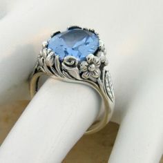 Vintage Estate 7.00 Carat Simulated Sky Blue Topaz Solitaire Filigree Ring. Floral Designs. 925 Solid Sterling Silver. Stamped 925. Excellent Condition/Like New. Vintage Silver Topaz Birthstone Ring, Vintage Sterling Silver Topaz Gemstone Ring, Vintage Sapphire Topaz Promise Ring, Vintage Sterling Silver Topaz Ring With Accent Stones, Vintage Silver Topaz Ring With Accent Stones, Vintage Sterling Silver Topaz Ring For Gift, Silver Topaz Birthstone Ring For Formal Occasions, Sapphire Topaz Ring In Sterling Silver, Classic Blue Topaz Jewelry Stamped 925