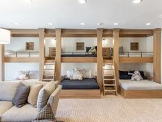 a living room filled with furniture and bunk beds