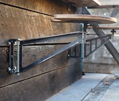 a bike rack attached to the side of a wooden building with metal bars on it