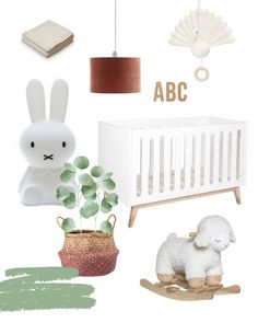 a baby's nursery with white furniture and accessories