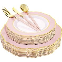 a stack of pink and gold plates with forks