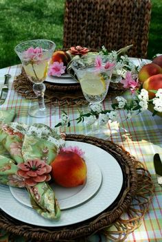 the table is set with plates, napkins, and fruit on top of it