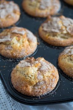 muffins with powdered sugar on top in a baking pan