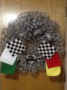 a wreath made out of mesh with checkered flags hanging from it's side