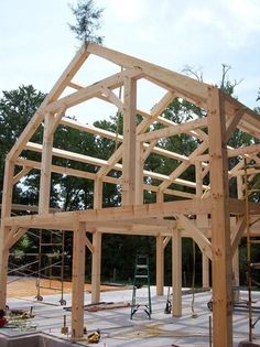 an unfinished house being built in the middle of a construction area with wood framing on it