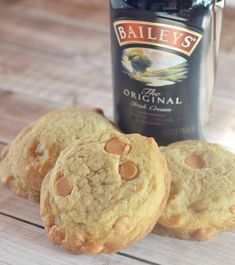 three cookies sitting next to a bottle of bailey's