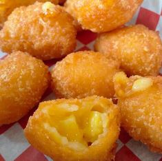 some fried food is on a red and white checkered table cloth