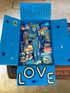 a blue box filled with lots of different types of items and writing on the inside