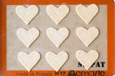 heart shaped cookies on a baking sheet ready to be made into valentine's day treats