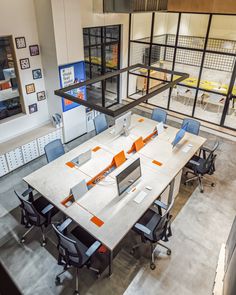 an office with multiple desks and chairs in it