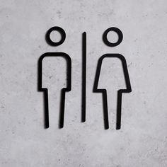 two people standing next to each other in the shape of a man and woman on a wall