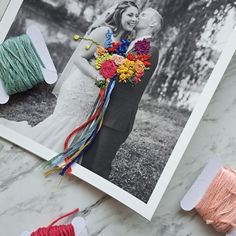 an image of a couple on their wedding day with yarn and flowers in the background