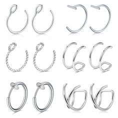 six pairs of silver hoop earrings with twisted ends, all in different shapes and sizes