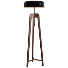 a wooden floor lamp with a black shade