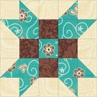 a blue and brown quilted star with flowers on the center is featured in this image