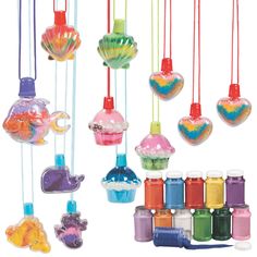 there are many colorful ornaments hanging from strings