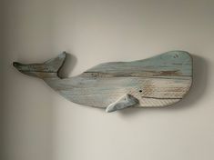 a wooden whale is hanging on the wall