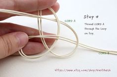 a hand holding an electric cord with instructions on how to wire it in the shape of a spiral