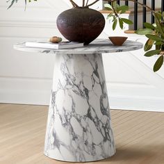 a marble table with a vase on top