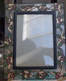 a decorative glass frame sitting on top of a table