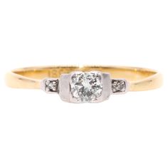 An Art Deco diamond, yellow gold, and platinum ring, comprising one transitional cut diamond, and two single cut diamonds, set in platinum, to a band of 18 karat yellow gold. This elegant ring is set to the centre with a transitional cut diamond (the precursor to the round brilliant cut diamond). The diamond is held aloft at the centre of the ring, within a protective square shaped setting. The principal diamond is wonderfully bright, white, and sparkly, with excellent clarity and colour. Steppe Diamond Trilogy Ring, Trilogy Ring, Art Deco Diamond, Platinum Ring, Elegant Ring, Gold Platinum, Jewelry Rings Engagement, Round Brilliant Cut Diamond, Round Brilliant Cut