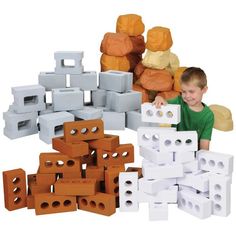 a young boy playing with blocks and bricks