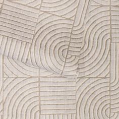 a close up view of an abstract pattern on fabric with wavy lines and curves in neutral colors