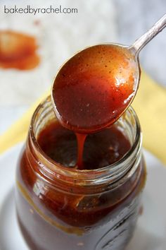 a spoon full of bbq sauce on top of a white plate