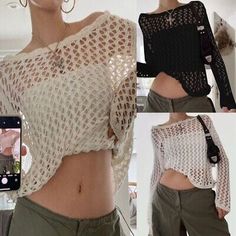 the woman is taking a selfie with her cell phone while wearing an open knit top