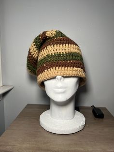 a knitted hat sitting on top of a white mannequin's head