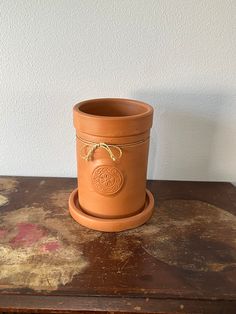 a brown pot sitting on top of a wooden table