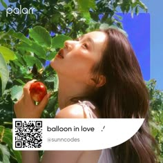 a woman is eating an apple in a tree with qr code on it that says balloon in love