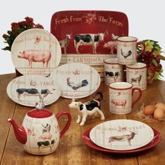 a table topped with plates and cups filled with farm animals