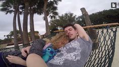 a man laying in a hammock next to a woman