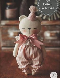 a teddy bear wearing a pink and white striped outfit with a bow on it's head