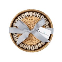 a wicker basket filled with shells and a ribbon