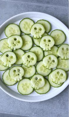 sliced cucumbers arranged on a white plate