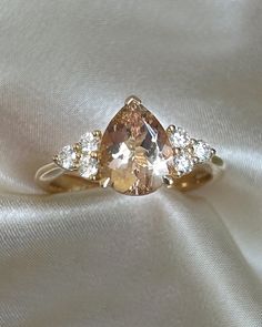 Pear cut morganite engagement ring with Trefoil set diamonds and an 18K yellow gold band Peach Morganite, Morganite Engagement, Morganite Engagement Ring, Morganite Ring, Pear Cut, Morganite, Pear