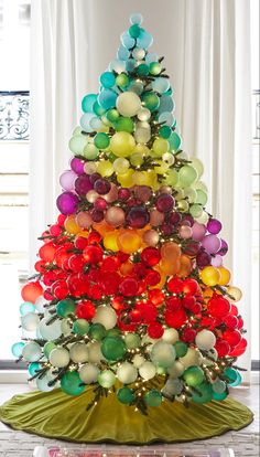 a very colorful christmas tree decorated with balloons