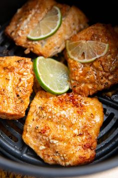 some meat and limes are cooking on a grill grates in the air fryer