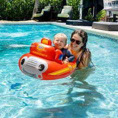 a woman and child are in the pool on an inflatable boat