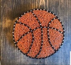 a basketball made out of string on top of a wooden table