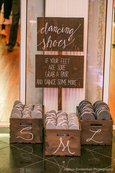 a sign that says dancing shoes in front of some wooden boxes with chalk writing on them