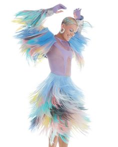 a woman in a colorful dress is dancing