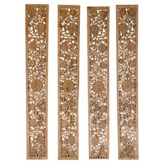 three carved wooden panels with flowers and leaves on the sides, all in different sizes