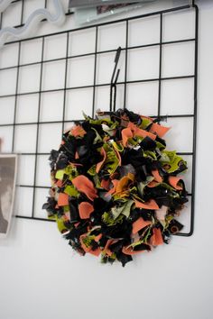 a wreath is hanging on a wire rack