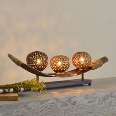 three decorative lights sitting on top of a table