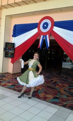 a woman standing in front of a red white and blue tent