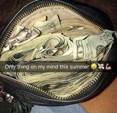 a purse filled with lots of money sitting on top of a person's lap