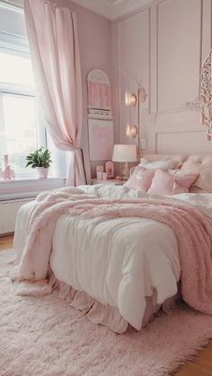 a bedroom with pink walls and white bedding, rugs on the wooden floor